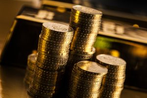 Picture of gold bars and coins for addition to physical gold IRAs.